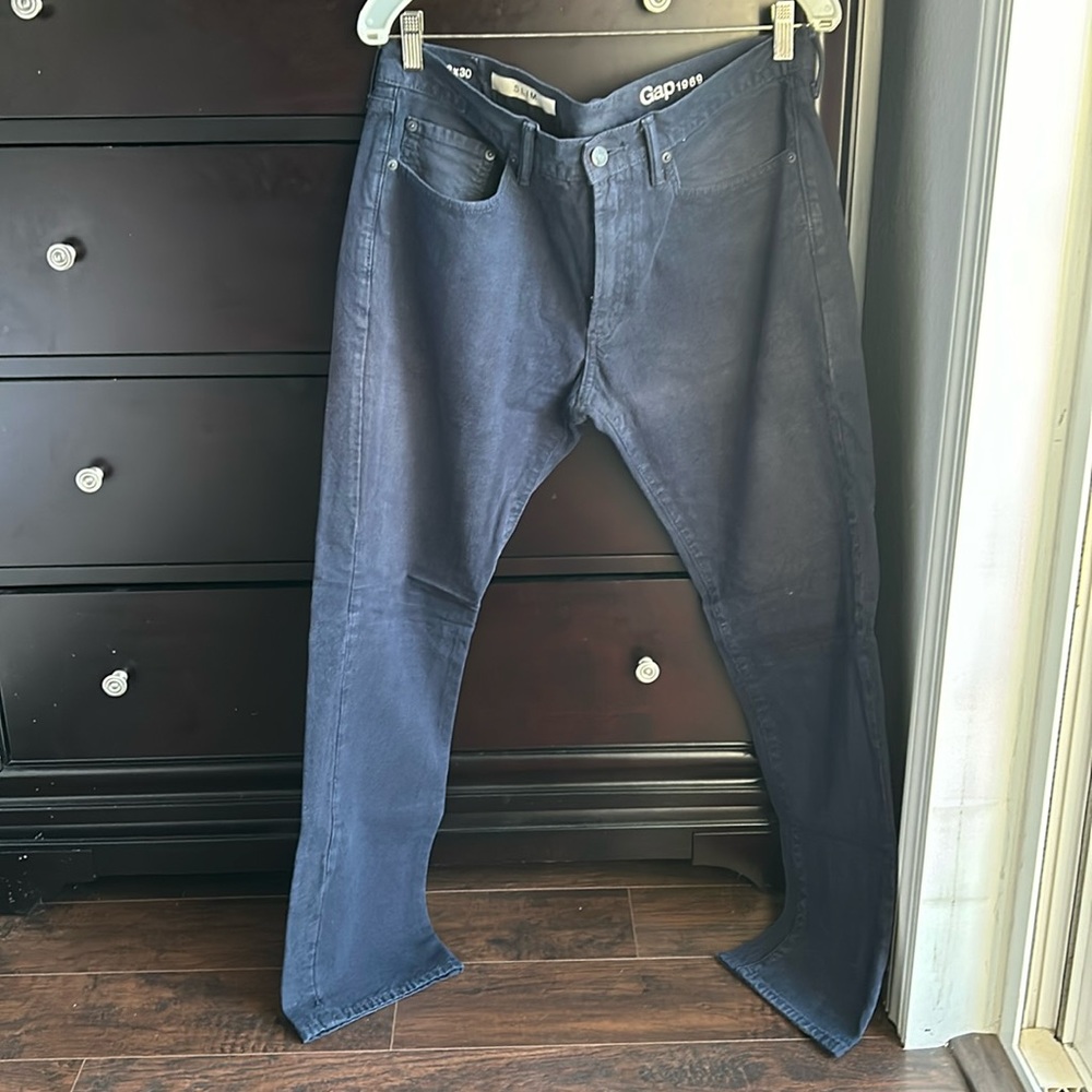 Worn mens Gap solid navy colored jeans, size 33x30
